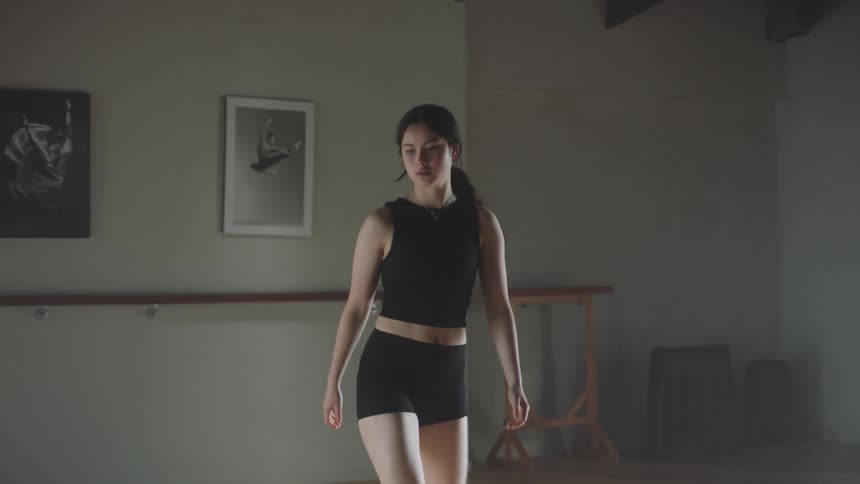 Female dancer practices alone in dance studio