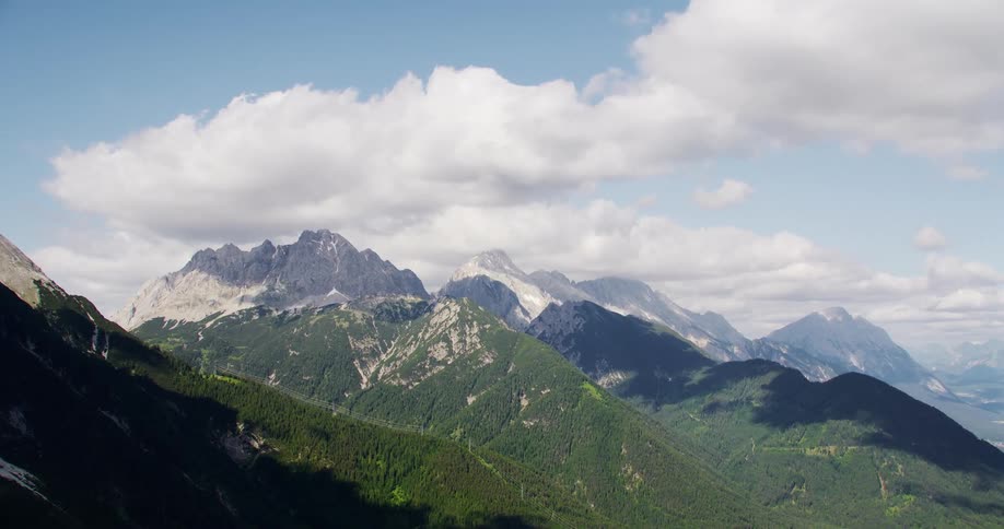 Mountains with vegetation and others with snow
