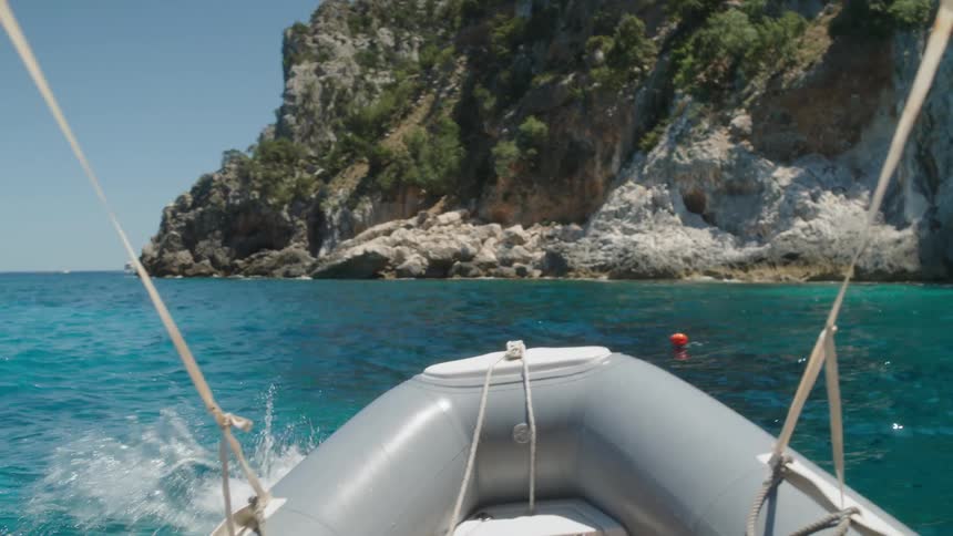 Man jumps into the ocean from a boat