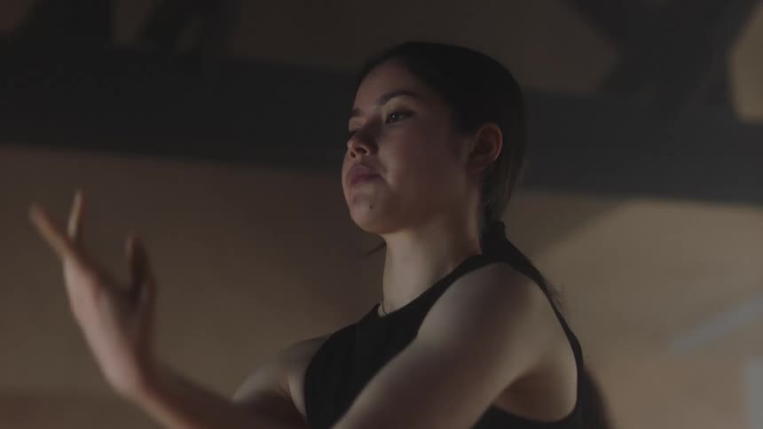A ballerina practicing some hand swing moves