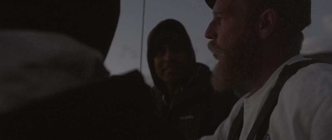 People are on a boat talking at dawn