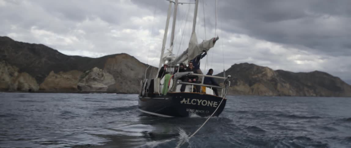 A boat is sailing pulling a rope behind it