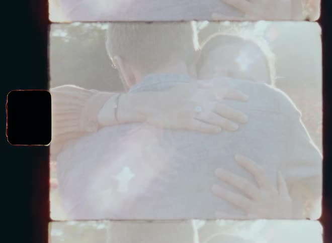 Man and woman with diamond ring on her finger living in harmony hug each other in the flower garden while celebrating the anniversary of their happy relationship during a romantic date in the evening time on a sunny and warm spring day