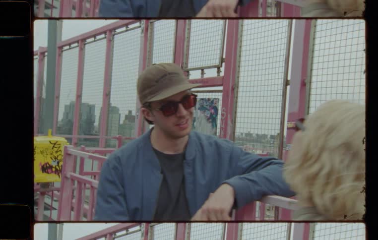 A man and a woman having a conversation beside the red barricade
