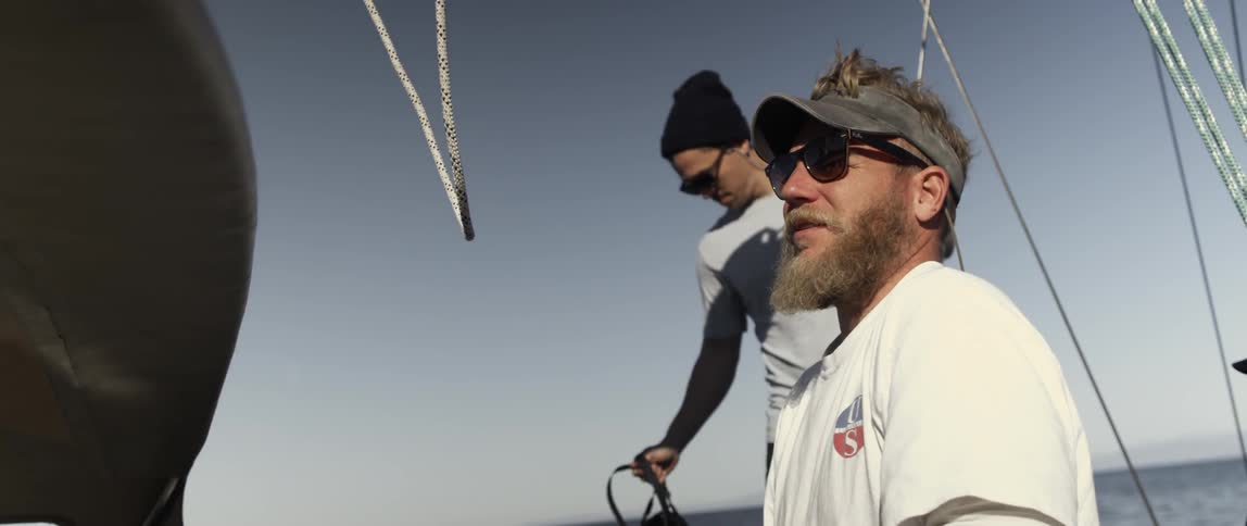 Men are on a ship talking on a clear day