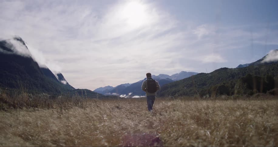 An explorer hiking the lone mountain range path