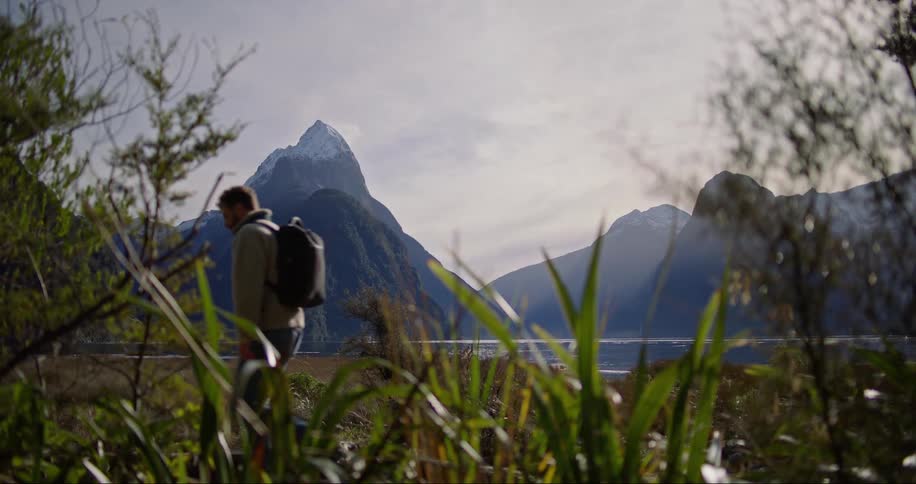 A man walking by the river bank