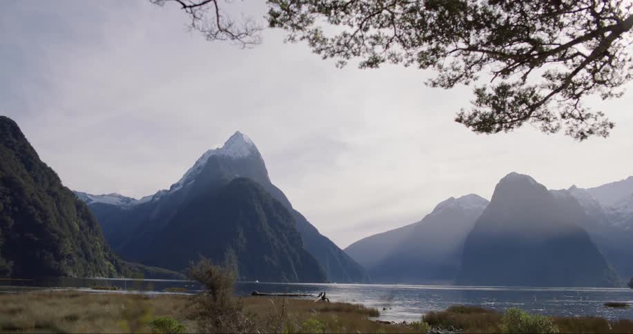 Natural horizon with a lake snowcapped mountains and vegetation