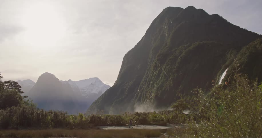 Man walking on a path close to a mountain