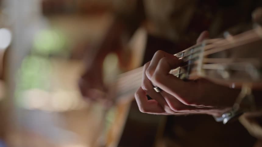 Closeup of hands playing the guitar