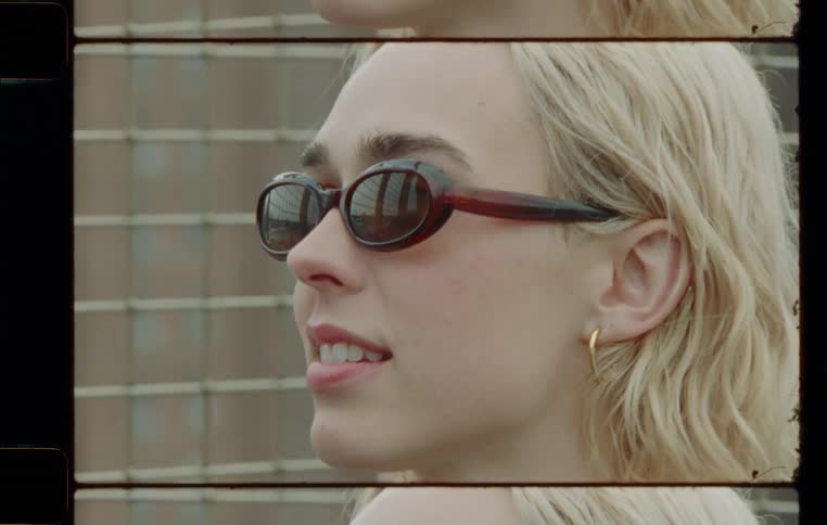 A woman wearing a sunglass with a gold earring while talking
