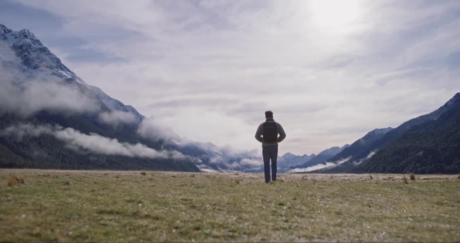 Man outdoors from the back hiking during day time