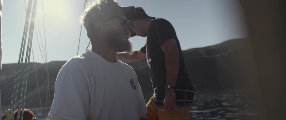 Two men are on a sailing boat