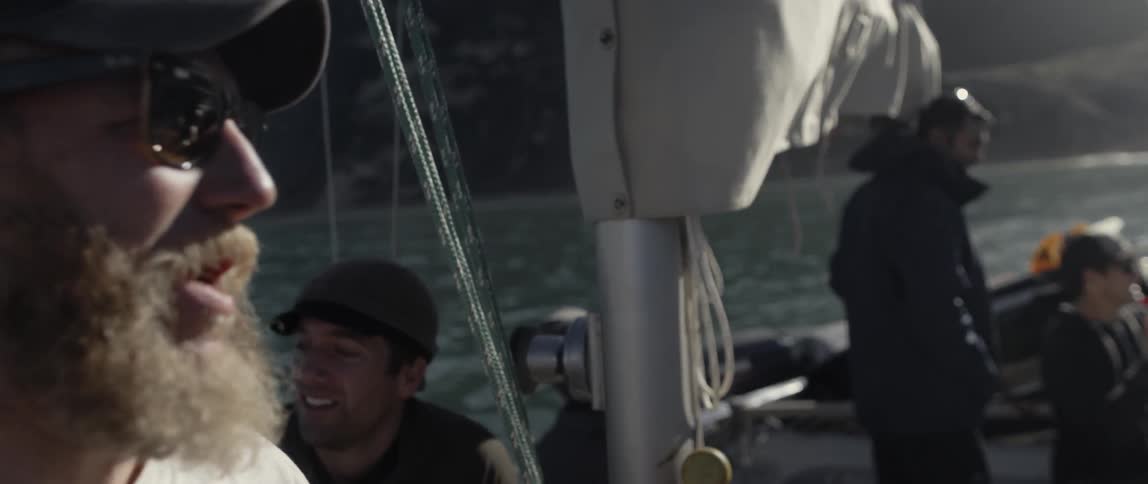 People are on a boat talking and sailing