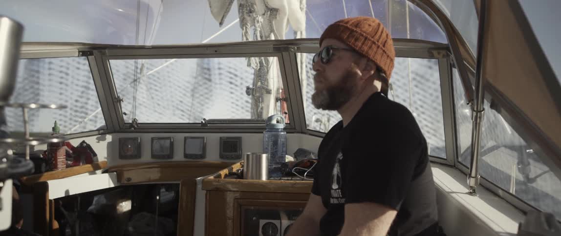 A bearded man is riding in a boat