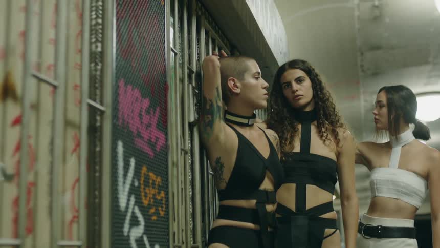 Young women posing in an empty white hallway