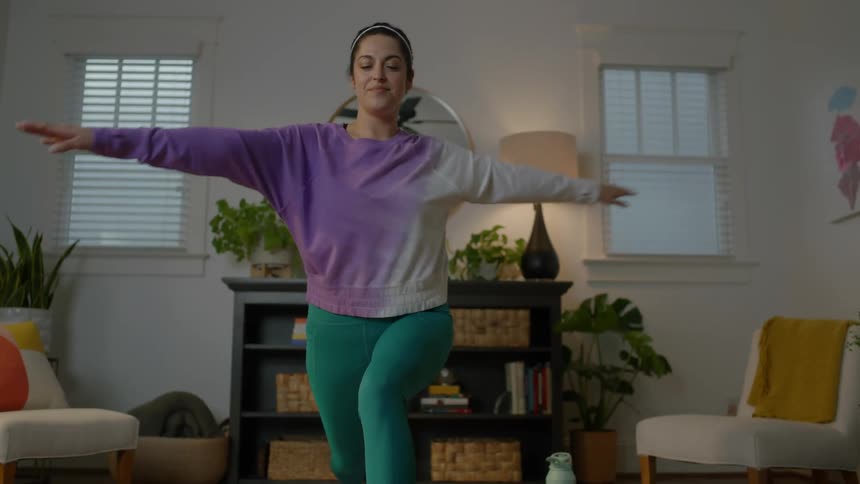 Woman stretches on mat indoors