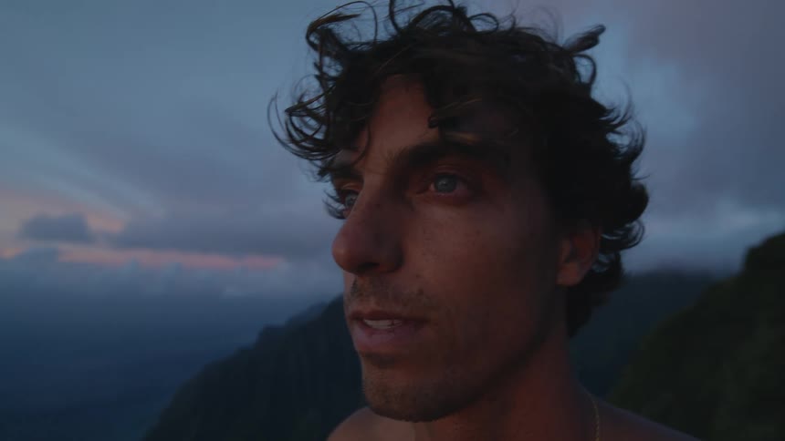 Closeup of a shirtless man in a natural setting observing calmly and feeling the vibe
