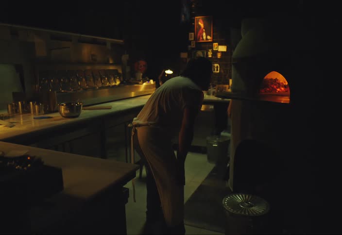 A man is waiting for food in the oven to be ready