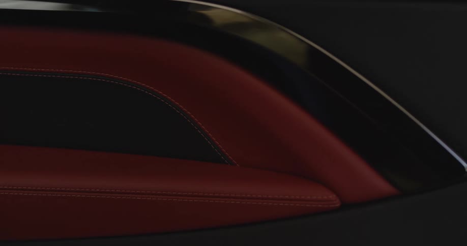 Closeup of stitched leather details in red and black colors
