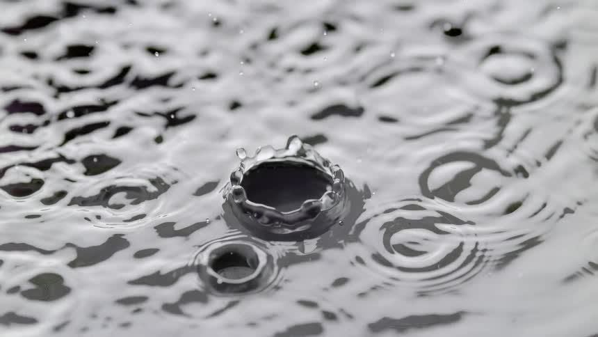 Water droplets in slow motion creating splashes and ripples