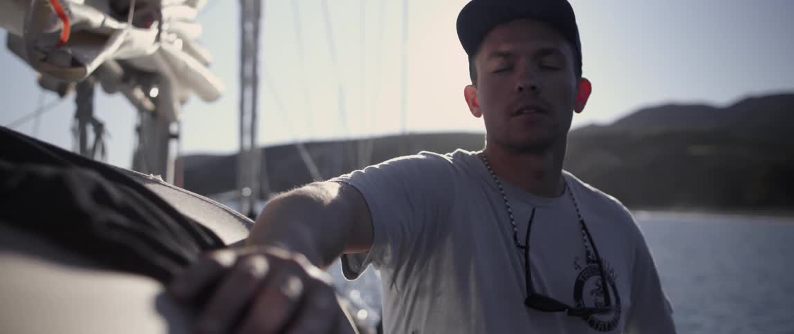 A man drums his fingers on a boat