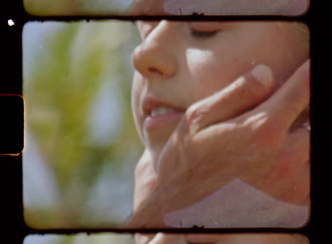 A man holds a womans face