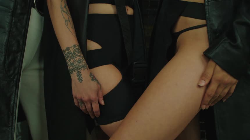Models wearing revealing clothes stand close to each other