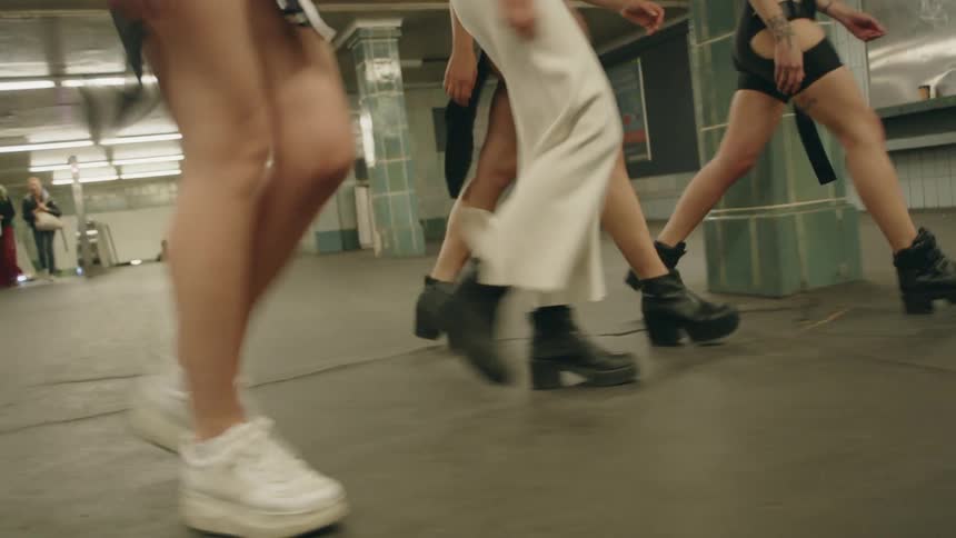 Women walk through the subway
