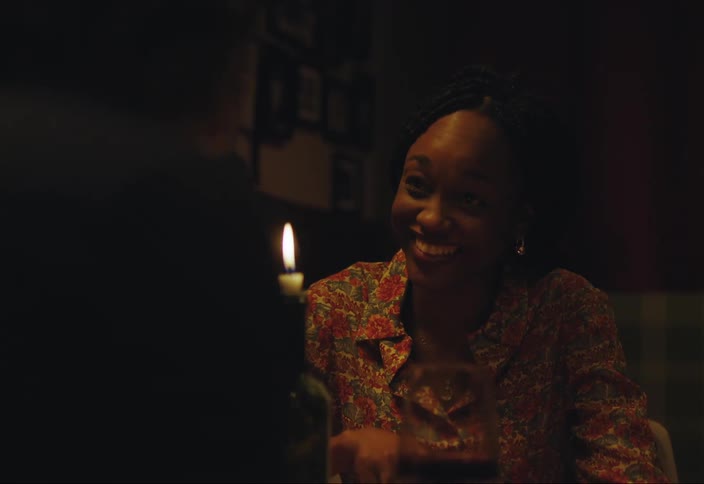 A woman on a date talking laughing and having wine with another person