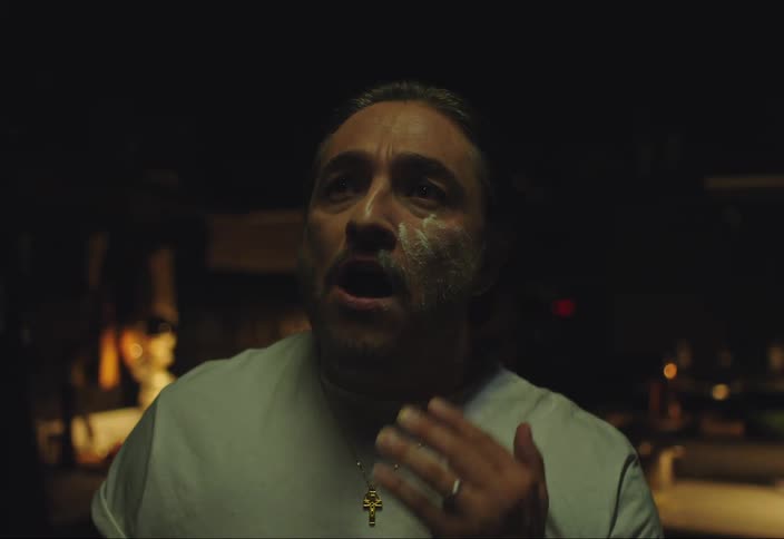 Portrait of a man performing singing and applying cream to his face