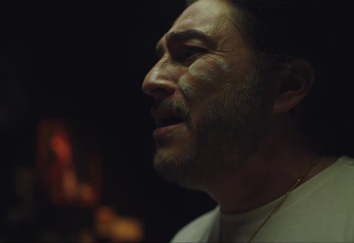 A man is singing as he cooks