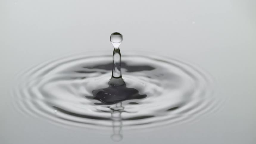 The droplet falls into the water