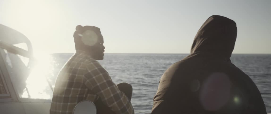Men ride on a boat on the ocean