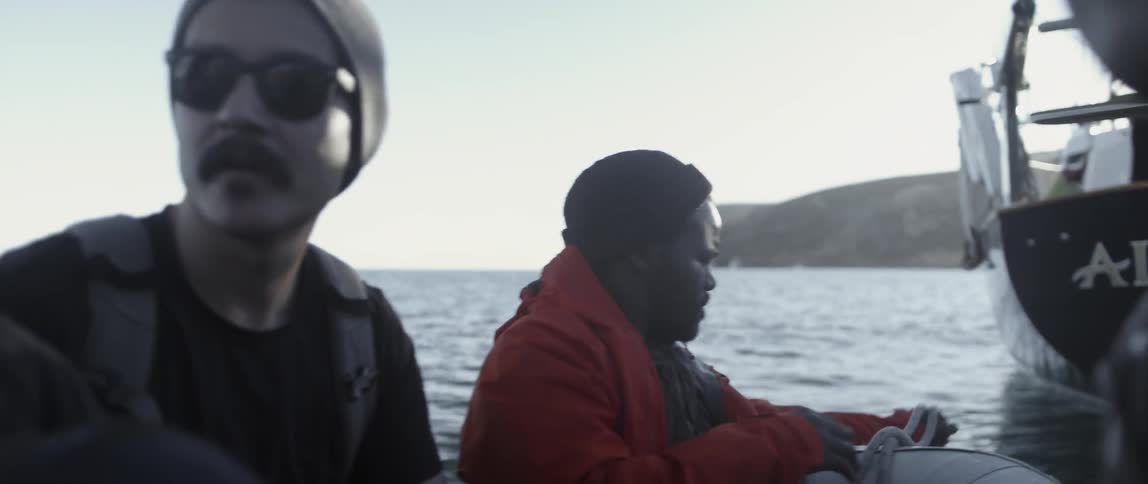 A man is pulling rope onto a raft