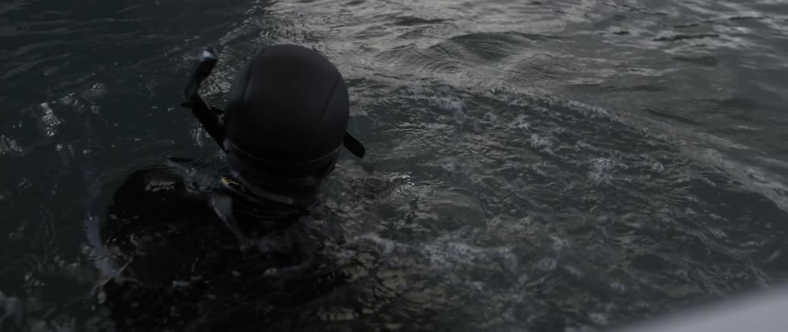 A man with a snorkel is looking around in the water