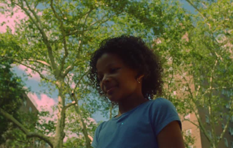 Girl standing on a park in the city sprinkled in glitter