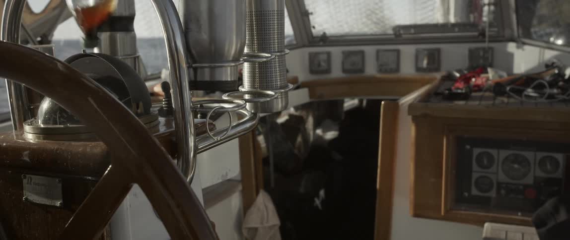 A man walks into the cabin below in a boat