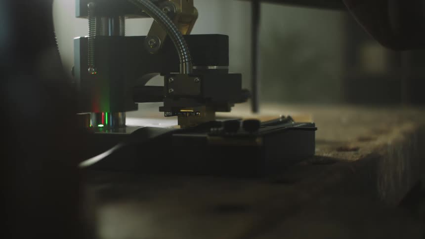 A gray metal machine on a wooden table