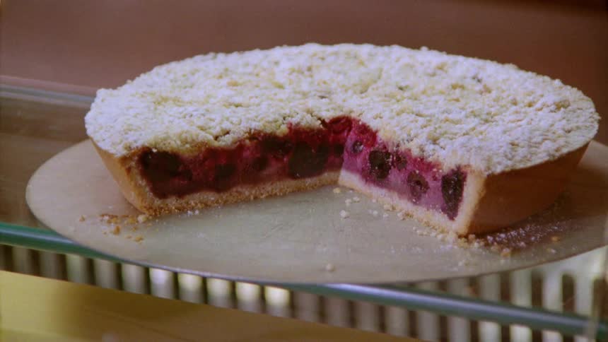A pie cut in half with filling and full of crumbs