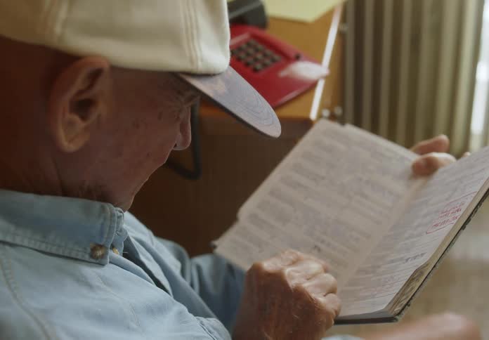 A man is reading his notebook