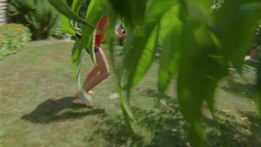 A redhaired boy playing with a water gun