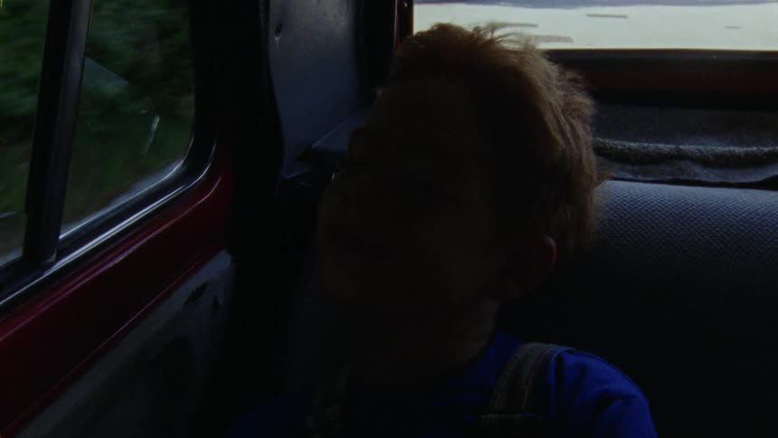 A relaxed child sitting in the car seat during the trip