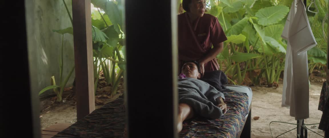 A woman lying down relaxed while receiving a massage