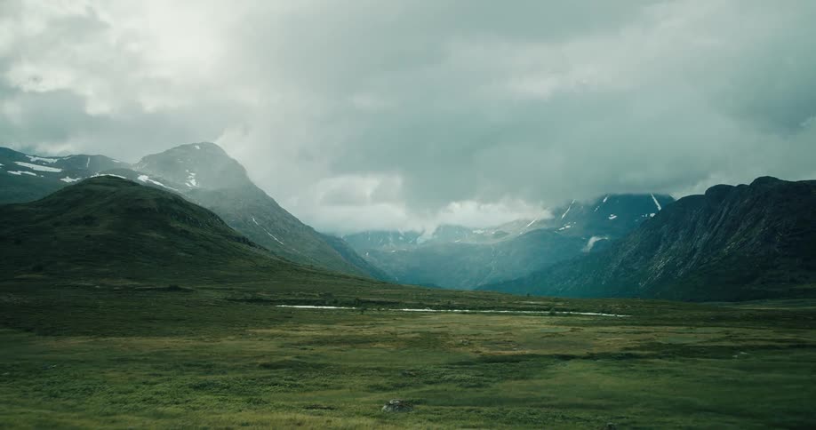 Landscape of plains mountains with vegetation and snow