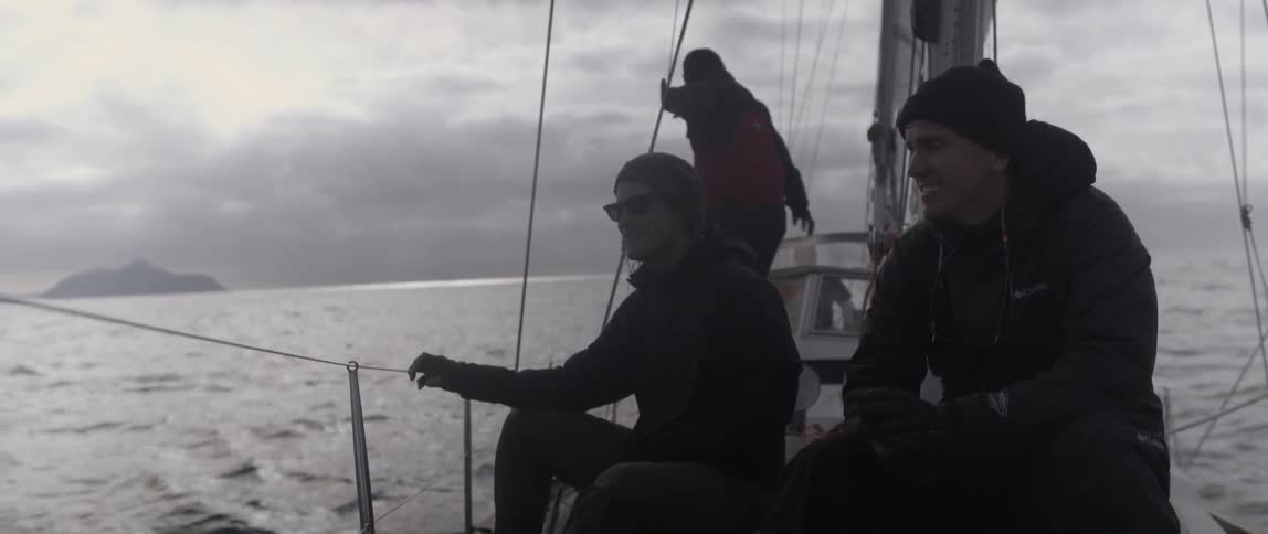 People are talking together on a boat on a cloudy day
