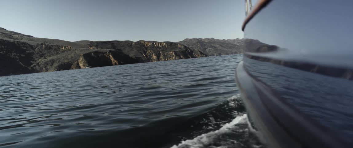 The boat is causing waves around it as it sails