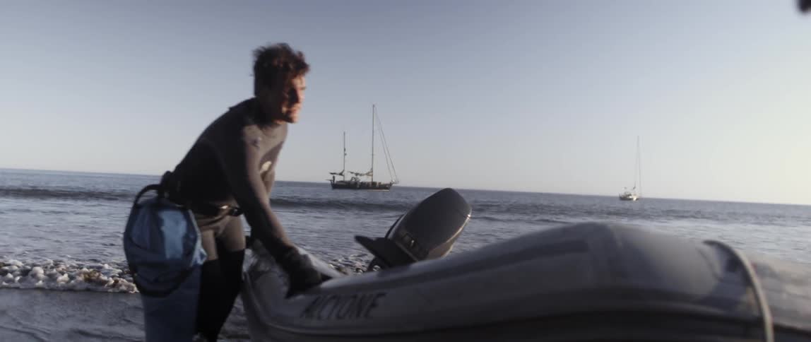 People pull a raft in from the water