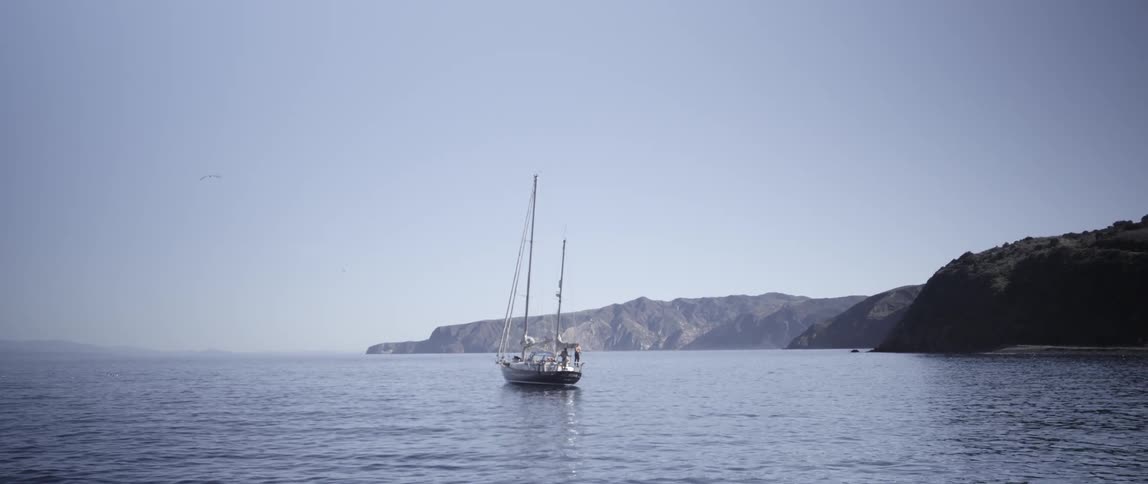 A boat floats in the water on a clear day
