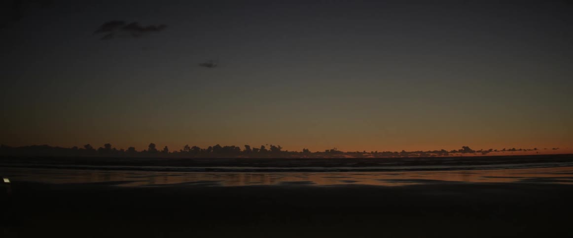 A car drives by on the beach